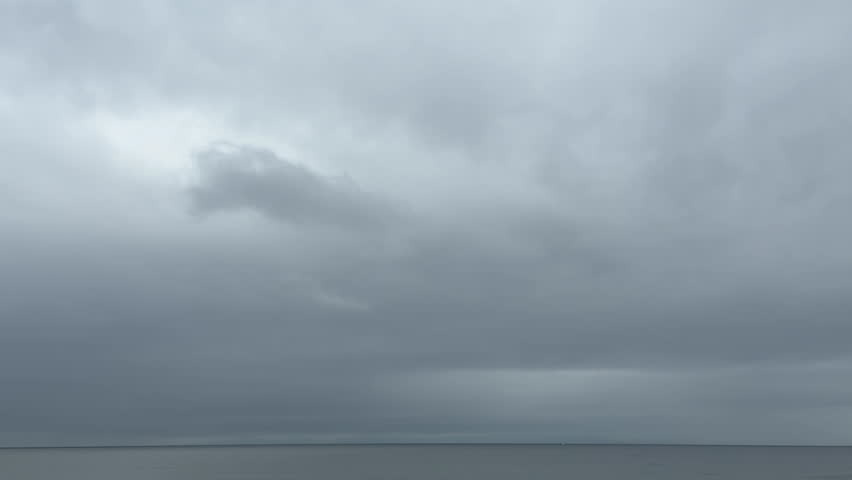 A dreamy cloudy sky landscape with leaden clouds spreading across the sky