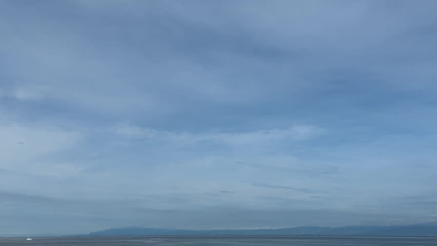 A beautiful seaside scene with soft clouds and a blue gradient