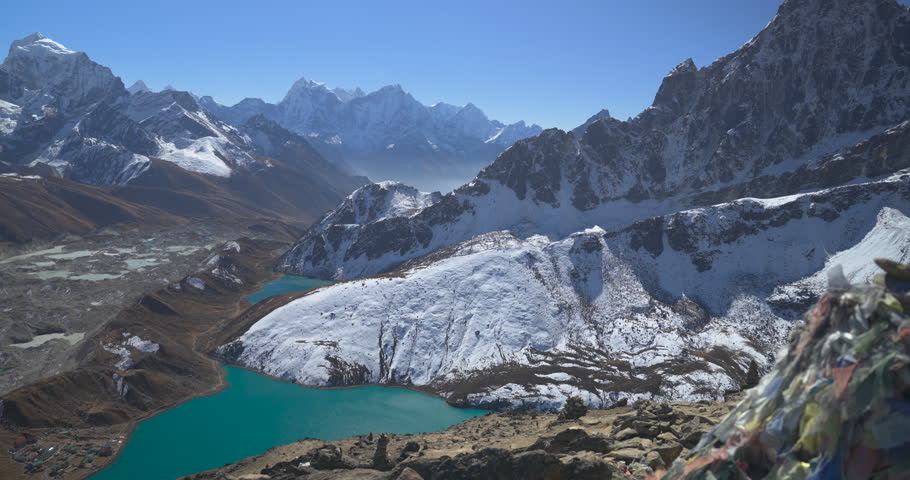 Gokyo Ri Everest region Nepal, camera pans across the high altitude landscape revealing turquoise lakes, Ngozumpa Glacier, and snow-capped Himalayan mountains.