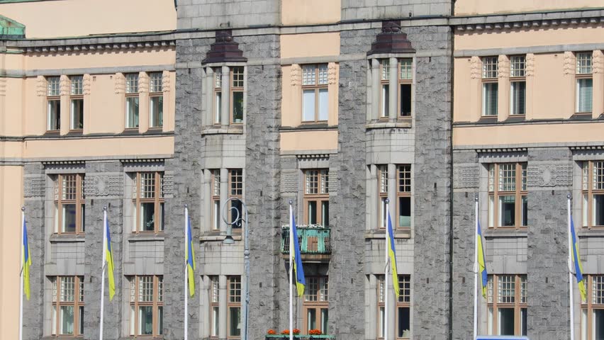 blue and yellow Ukrainian flag near a building during the war