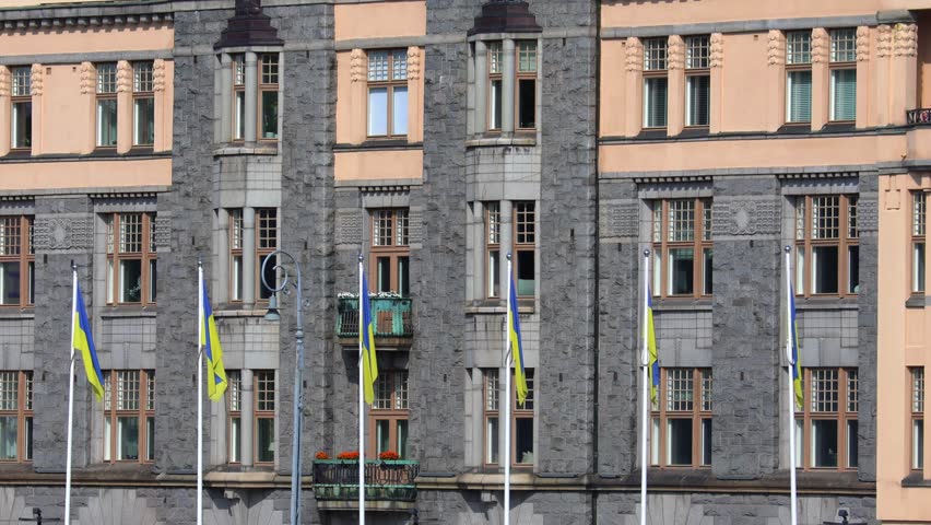 blue and yellow Ukrainian flag near a building during the war