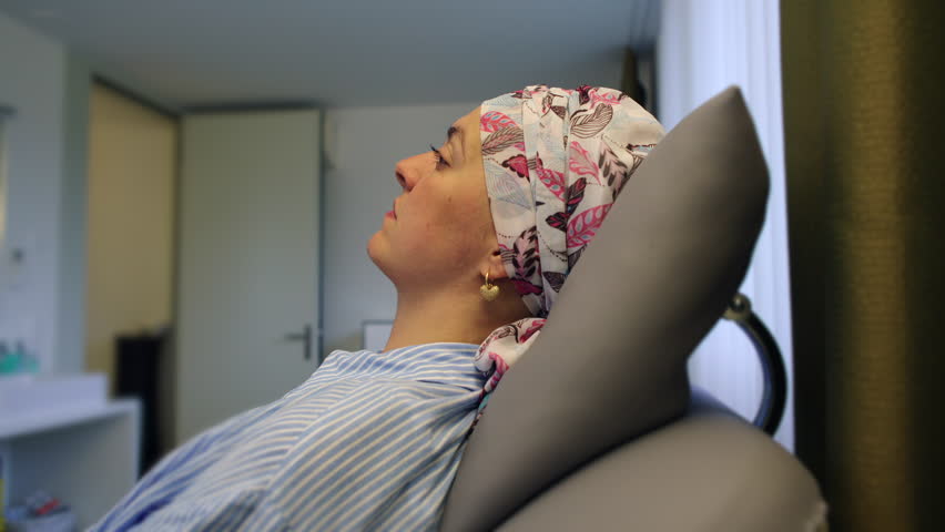 Woman undergoing cancer treatment in outpatient clinic, emphasizing oncology care, patient wellbeing, medical support, healing process, determination, recovery, endurance and emotional resilience