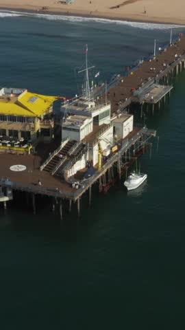 AERIAL: Overlooking Santa Monica Pier in Los Angeles, California, Sunny, Blue Sky 