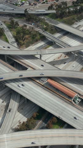 AERIAL: Slowly Circling over Judge Pregerson Huge Interchange showing multiple Roads, Bridges, Highway with little car traffic in Los Angeles, California on Beautiful Sunny Day 