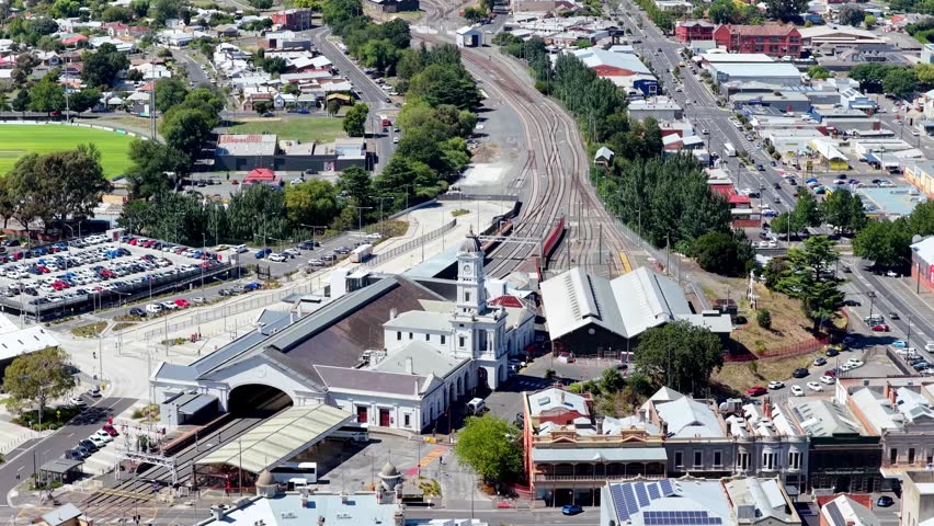 Railway station of Ballarat city over to Town Hall building in downtown – aerial panorama.