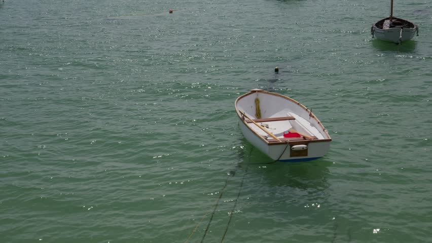 Wooden Dinghy Boat Floating Near St Ives Harbour In Cornwall, England, UK. Static Shot