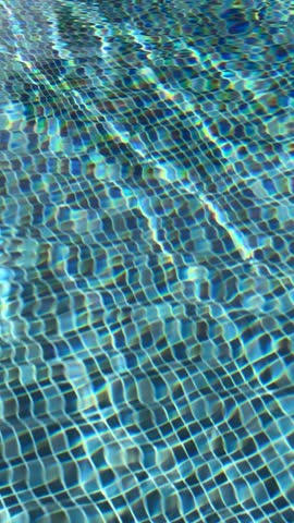 Swimming pool with blue crystal clear water surface and ripple wave background