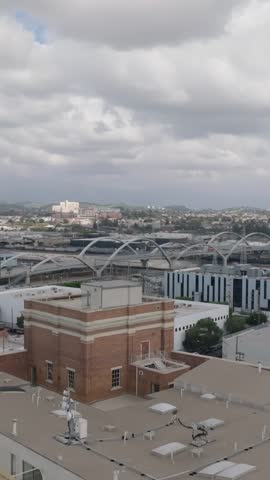 Aerial panoramic footage of modern design traffic structure in urban borough. Long Sixth Street Viaduct spanning river, rail tracks and freeway. Los Angeles, California, USA
