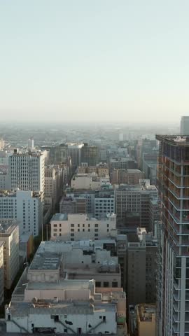 Construction Site on Skyscraper Tower in Downtown Los Angeles, California Skyline in Beautiful Sunset light, City in development, Scenic Aerial Dolly left