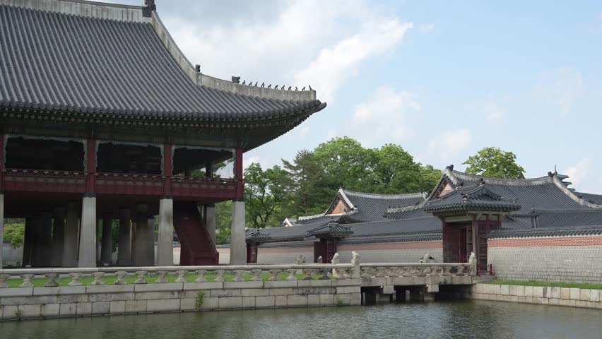 Antique wooden pavilion standing elegantly over a tranquil pond