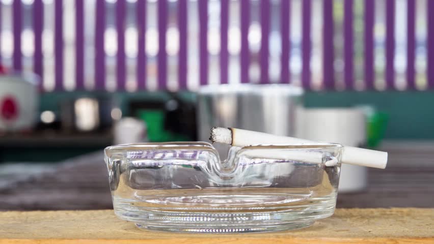 Extinguish a cigarette in an ashtray full of butt cigar stop smoking concept unhealthy lifestyle 4k