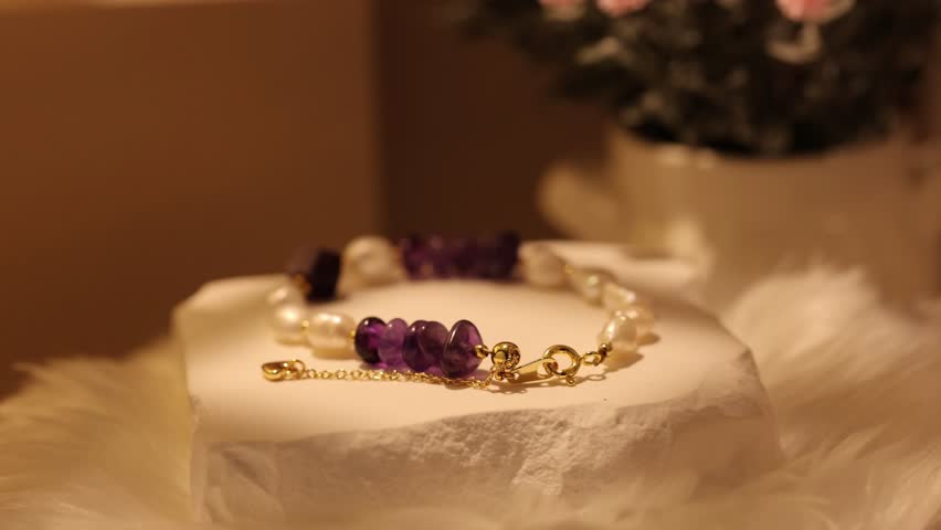 This display features natural stone bracelets with different types of stones. The rotating stand allows a full view of each bracelet in clear light and focus.