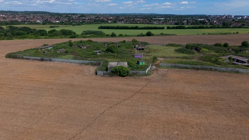 WWII gun emplacements at Chadwell Heath filmed in a forward drone flyover over Whalebone Lane anti-aircraft battery ZE1, concrete bunkers and surrounding Essex fields.