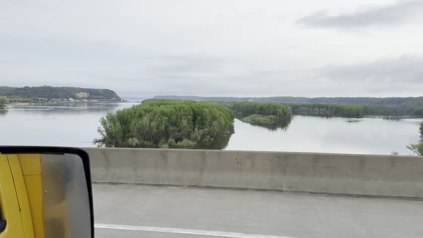 Passing through the Maddison river bridge between Wisconsin and Iowa states on a road trip.