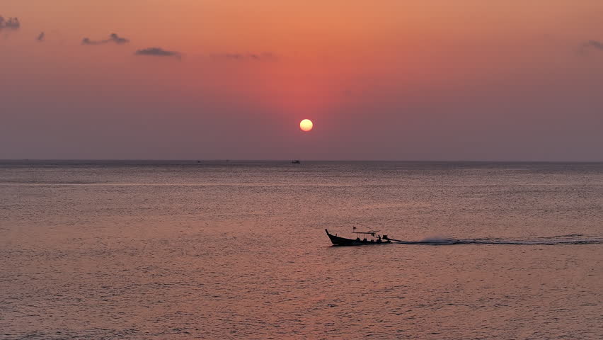 Traditional long tail boat sailing during sunset, Thailand 