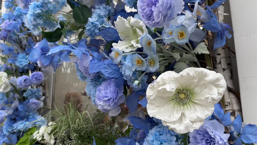 Blue and white artificial flowers around the front door