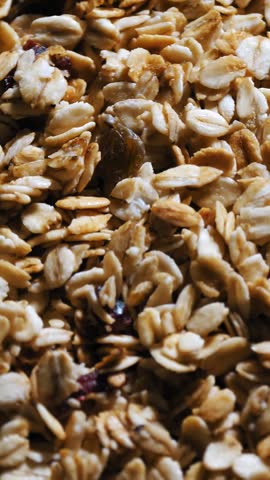 Granola. Oat flakes. Dry oat flakes, grains with berries and nuts. close-up. top view. Food background. Macro rotation. healthy, organic food. Gastronomy. Rotation food.