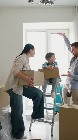 Happy young family moving into a new home together