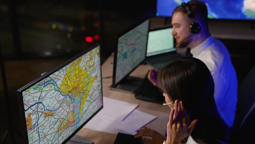 Transport dispatchers coordinating cargo delivery on computer map