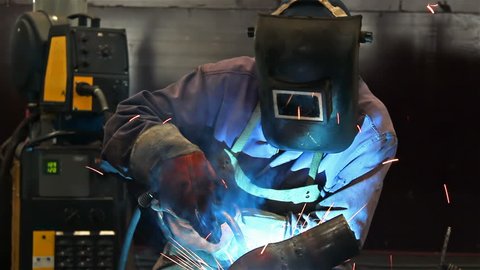Welding work ; welder welding metal material in heavy industry manufacturing video clip