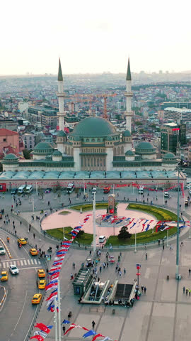 Taksim Square aerial drone shot in Istanbul Beyoglu. Panoramic view of iconic Republic Monument, Istiklal Street and urban city landscape.