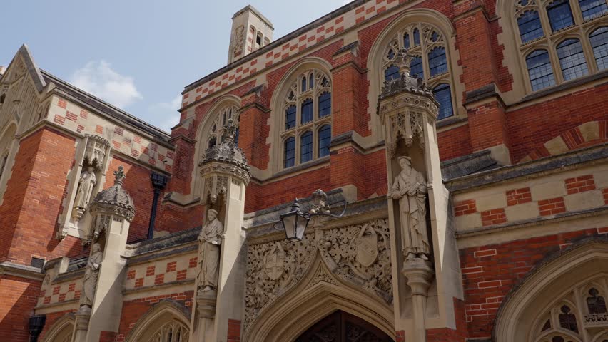 Architectural detail of Selwyn College, a constituent college of the University of Cambridge, showing statues and red and white checkered brickwork