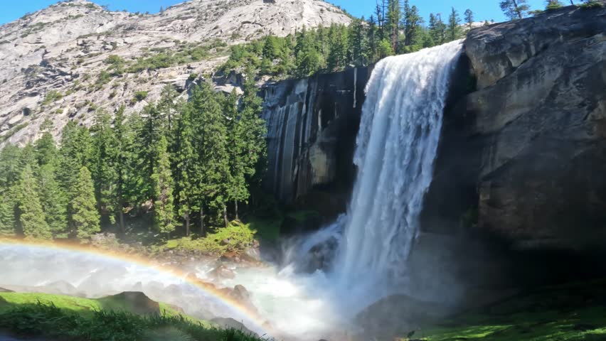 Beautiful view of Vernal Fall waterfall in Yosemite National Park, California, featuring rushing water, granite cliffs, forest scenery, and pristine wilderness landscapes