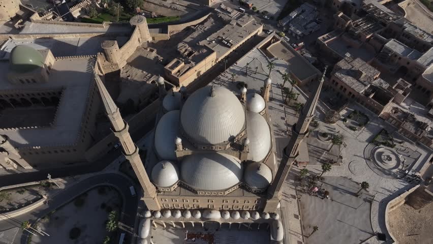 Aerial drone footage of the Muhammad Ali Mosque at the Citadel of Cairo, Egypt. The video showcases Islamic architecture, domes, minarets and the historic courtyard from a bird