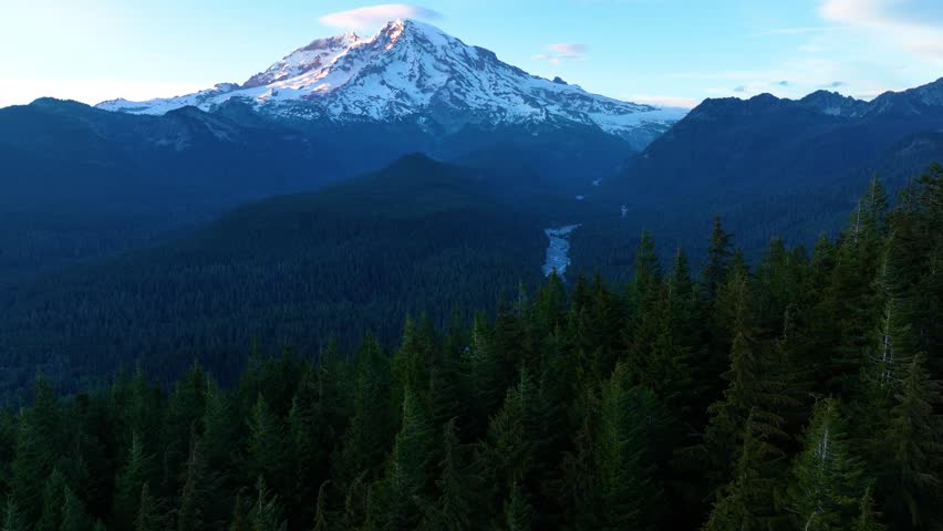 Mount Rainier Above Forested Mountains At Dusk