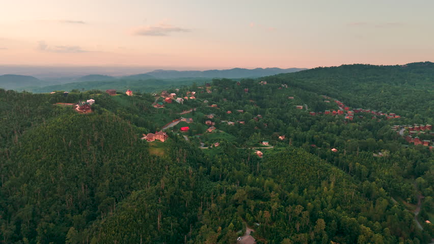 Aerial view of mountain resort houses in Gatlinburg, Tennessee near the Great Smoky Mountains with vibrant greenery and scenic hills