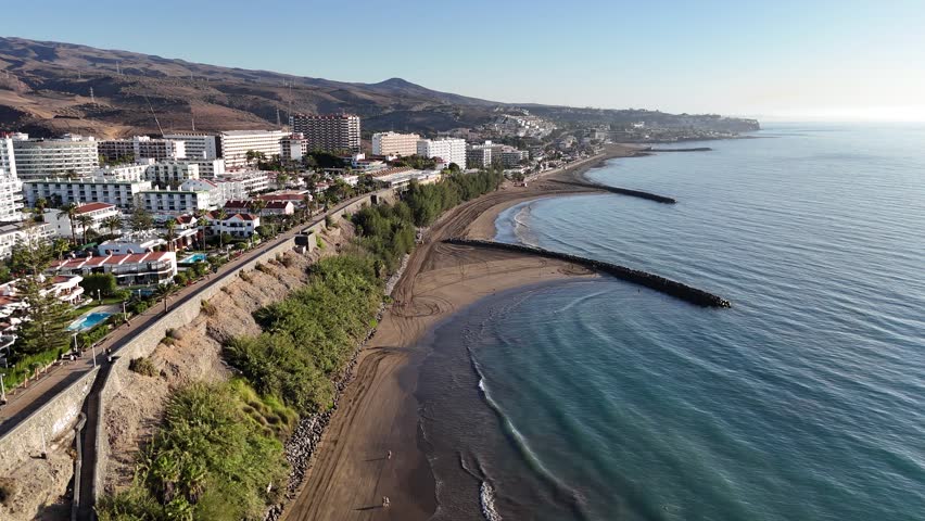 Aerial panorama flight with hotels in Playa del Ingles, beach, hills and Atlantic ocean on Canary Island Gran Canaria, Spain