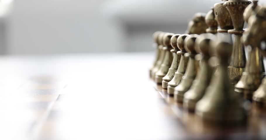 Playing chess. Man making first move with pawn, closeup