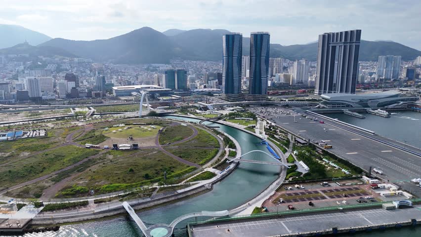 Aerial view of the modern waterfront, park, and skyscrapers in Busan, Busan, South Korea.