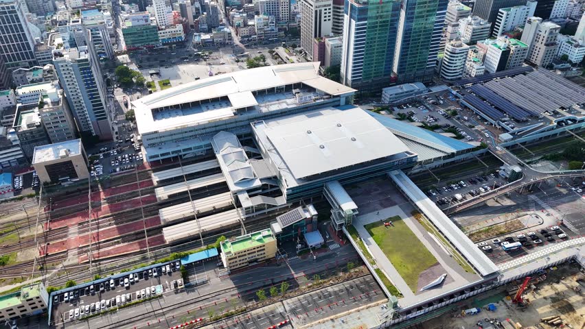 Aerial view of Busan station with its modern architecture, railway tracks, and surrounding urban cityscape in Busan, South Korea.