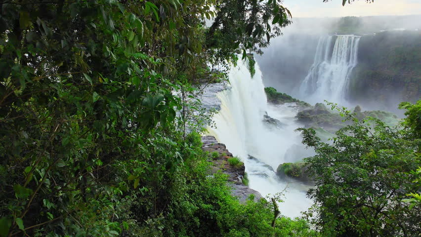 Water flows over waterfalls in Brazil at Iguazu Falls, the largest waterfall system in the world. 