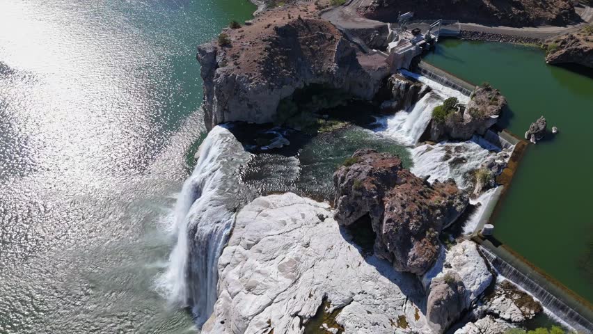 High aerial orbit shot of Shoshone Falls along Snake River in Twin Falls, Idaho on a sunny day in spring.