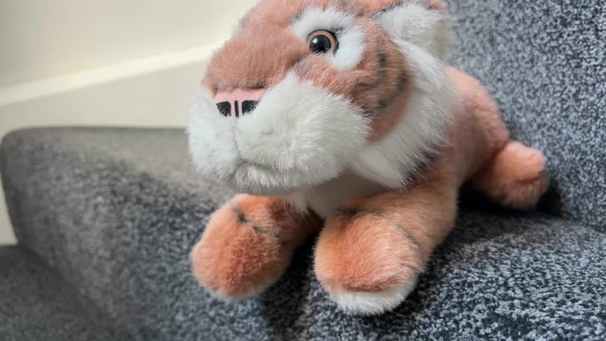 Plush Tiger Toy Sitting on Sofa Close Up