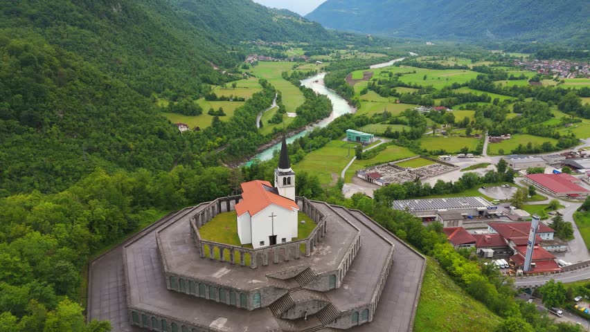 Kobarid Ossuary honors Isonzo Front history above Soca Valley in Slovenia, drone pull-back shot