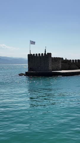 Nafpaktos, Aetolia Acarnania, Western Greece - March 15th, 2026 - aerial and street footage of the historical town, venetian harbor, venetian castle and fortress, clock tower, architecture, boats, former mosques, beaches and the landscapes around