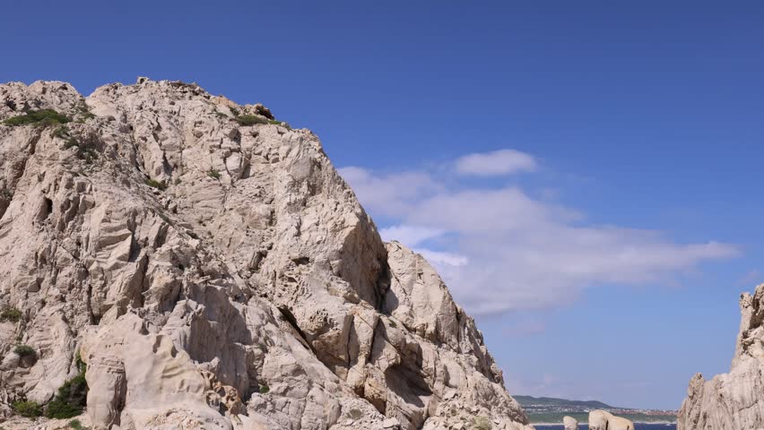 View of the iconic rock formations of Los Arcos rising from the blue sea under a clear sky in Cabo San Lucas, Baja California Sur, Mexico.