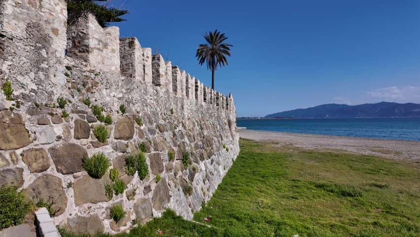 Nafpaktos, Aetolia Acarnania, Western Greece - March 15th, 2026 - aerial and street footage of the historical town, venetian harbor, venetian castle and fortress, clock tower, architecture, boats, former mosques, beaches and the landscapes around