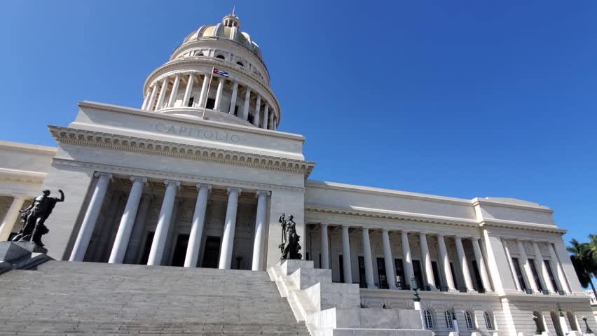 View of the neoclassical Havana Capitol building with its grand staircase and columns under a clear blue sky in La Habana, La Habana, Cuba.