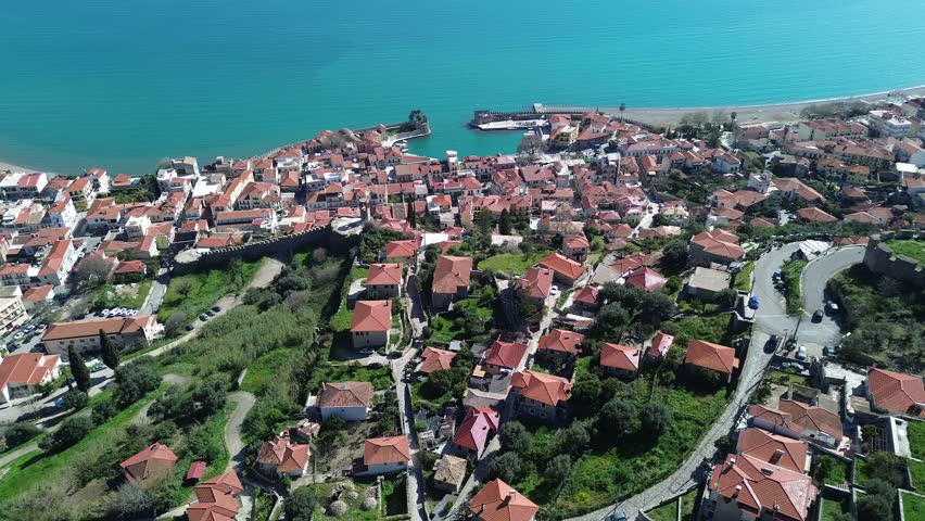 Nafpaktos, Aetolia Acarnania, Western Greece - March 15th, 2026 - aerial and street footage of the historical town, venetian harbor, venetian castle and fortress, clock tower, architecture, boats, former mosques, beaches and the landscapes around