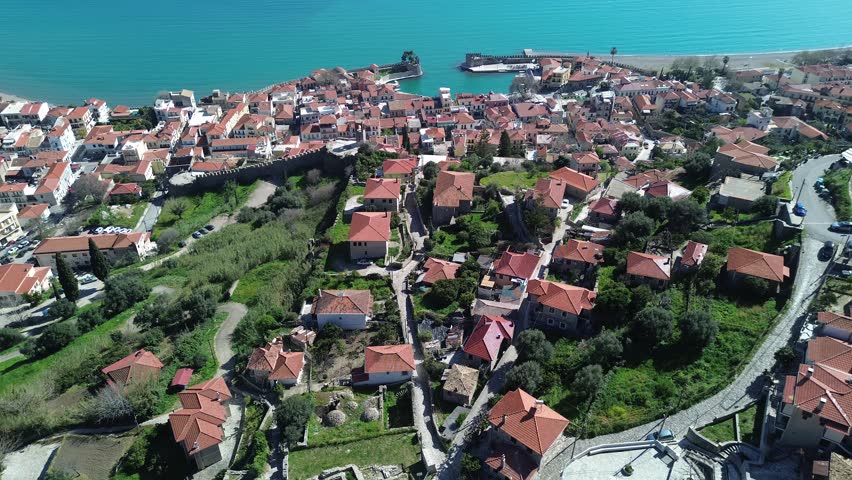 Nafpaktos, Aetolia Acarnania, Western Greece - March 15th, 2026 - aerial and street footage of the historical town, venetian harbor, venetian castle and fortress, clock tower, architecture, boats, former mosques, beaches and the landscapes around