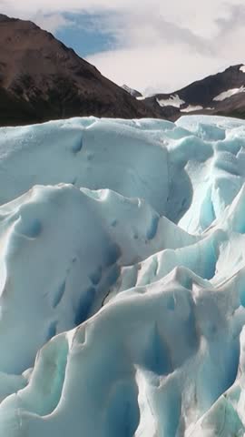Witness the breathtaking formations of glaciers at Los Alerces National Park in Patagonia, Argentina. The stunning blue hues and massive ice structures create an awe-inspiring landscape in the Andes.