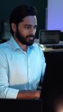 Serious Indian programmer writing code on desktop computer at the office. Software engineer reviewing data for developing program - Powered by Shutterstock - Get 15% off with code: PIKWIZARD15