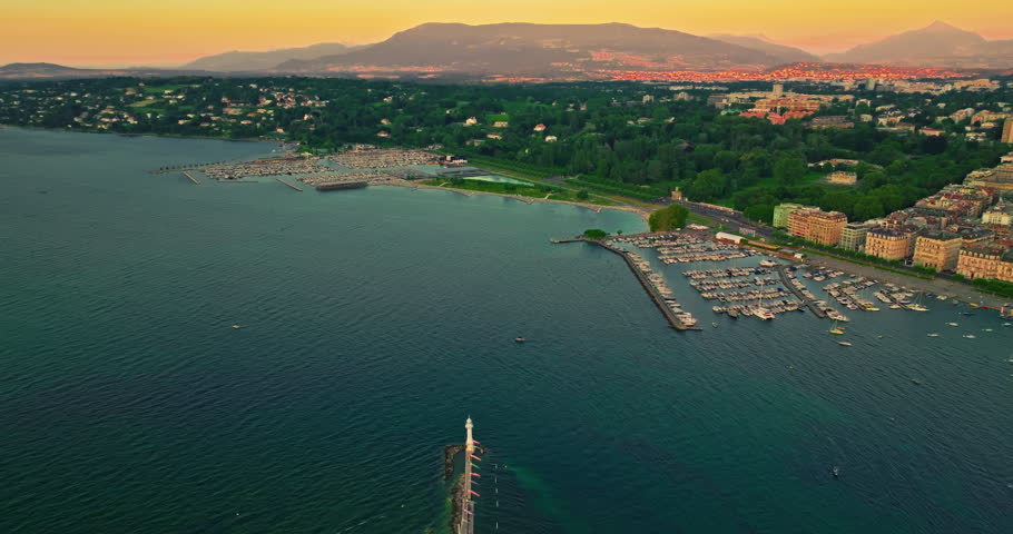 Establishing shot of Geneva city. Aerial view of the Swiss lake town. Rooftops of houses and the lake bay