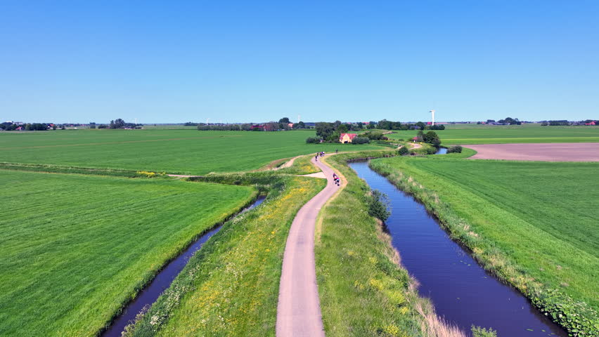 Aerial view of cyclists participating in the Eleven Cities cycling tour through the countryside of Friesland on a beautiful spring day in the Netherlands, Europe.