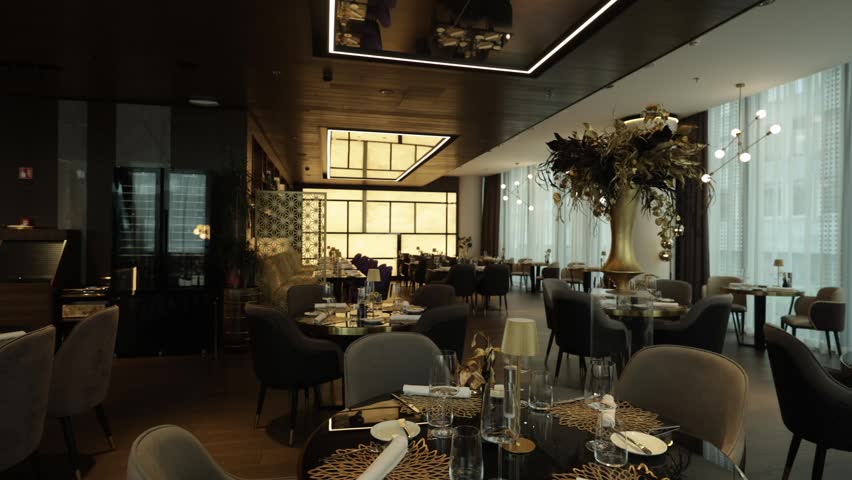 Stylish hotel dining room with elegant tables and large glass window