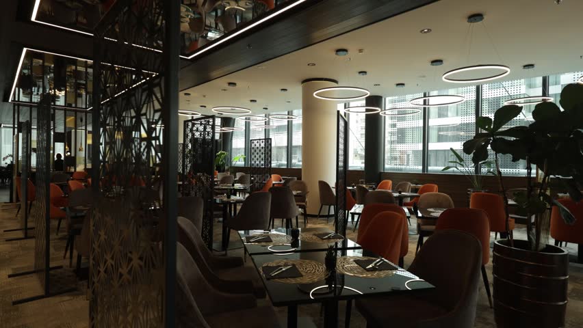 Contemporary hotel restaurant interior with large green plants